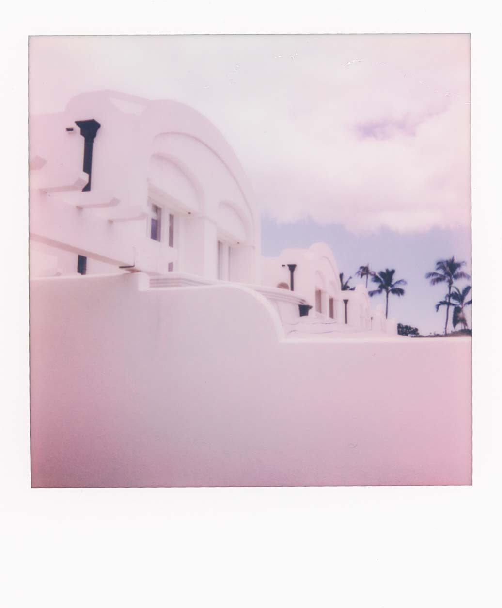 Polariod of white villas. The color is mildly pink.